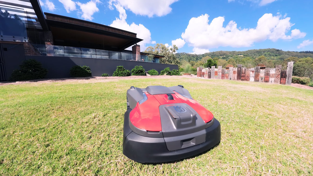 Automower 580 EPOS on lawn near garden feature