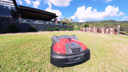 Automower 580 EPOS on lawn near garden feature
