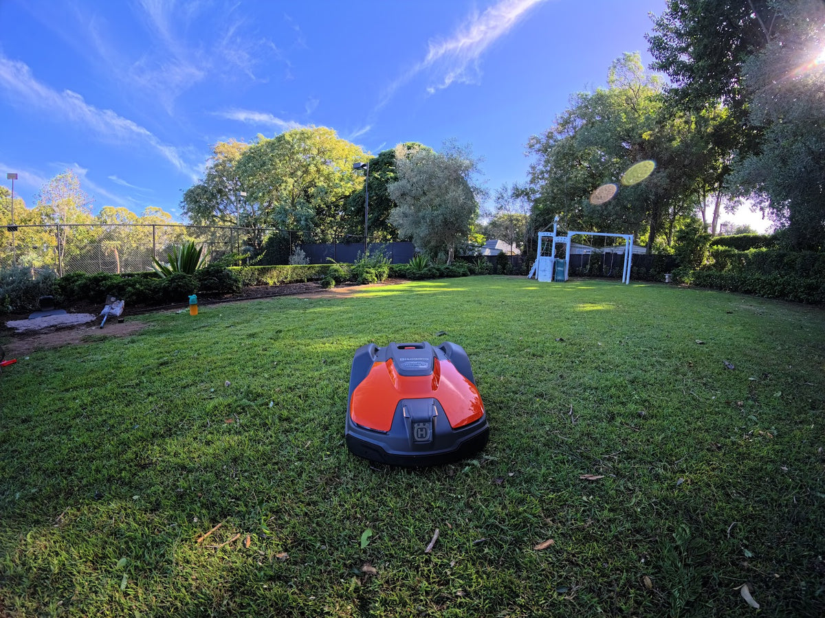 Automower 540 EPOS wide shot on lawn near property