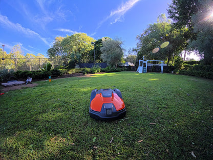 Automower 540 EPOS wide shot on lawn near property