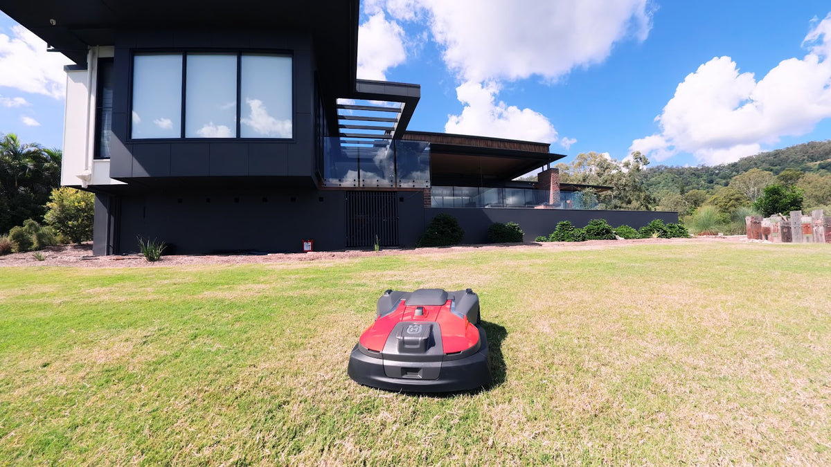 Automower 580 EPOS on lawn near modern house