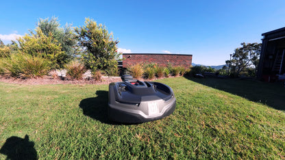Automower 435X AWD wide shot on residential lawn